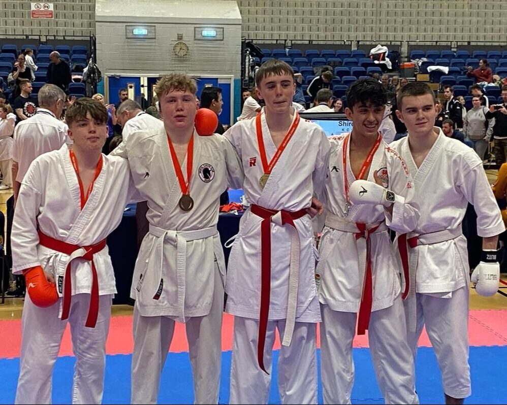 The club's teenage squad in club gis wearing their medals
